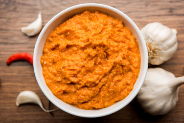 Garlic chutney, made using lahsun/lehsun originating from the India, served in a bowl over moody background. selective focus