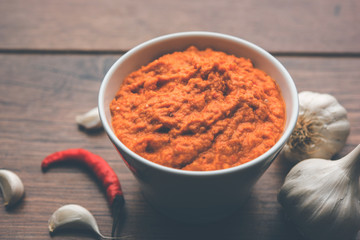 Garlic chutney, made using lahsun/lehsun originating from the India, served in a bowl over moody background. selective focus