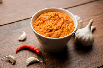 Garlic chutney, made using lahsun/lehsun originating from the India, served in a bowl over moody background. selective focus