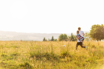 Fototapeta na wymiar Boys running in the meadow, having fun