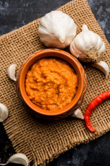 Garlic chutney, made using lahsun/lehsun originating from the India, served in a bowl over moody background. selective focus