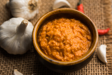 Garlic chutney, made using lahsun/lehsun originating from the India, served in a bowl over moody background. selective focus