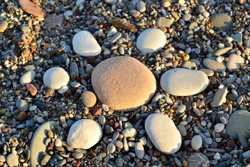 Stone sun on the beach sea