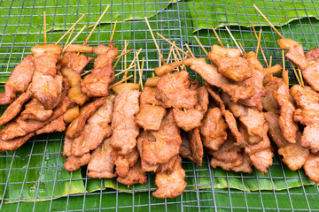 Fried Pork stick on grid market, Thai cuisine traditional signature street food (selective focus)
