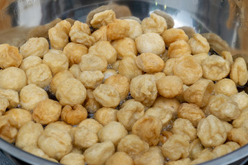 Fried fish ball in the big pan for sale in street foods market