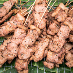 Fried Pork stick on grid market, Thai cuisine traditional signature street food (selective focus)