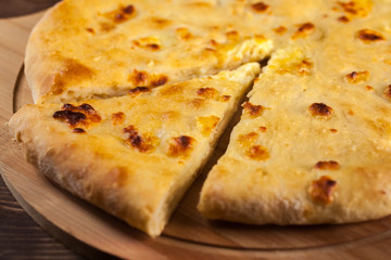 Georgian traditional food khachapuri on the wooden dish