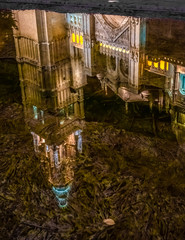 Fototapeta na wymiar Reflection ofThe Primate Cathedral of Saint Mary of Toledo, one of the three 13th-century High Gothic cathedrals in Spain and considered the magnum opus of the Spanish Gothic style