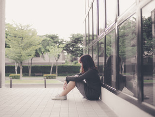 Asian woman sitting alone and depressed,Portrait of tired young woman. Depression