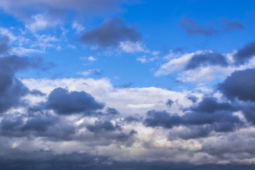 grey stormy clouds on blue sky background
