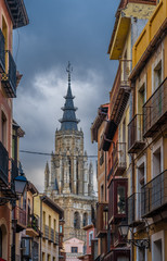 View of the cathedral bell tower from the  streets of the old city center of Toledo, Castile-La Mancha, Spain