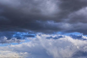 grey stormy clouds on blue sky background