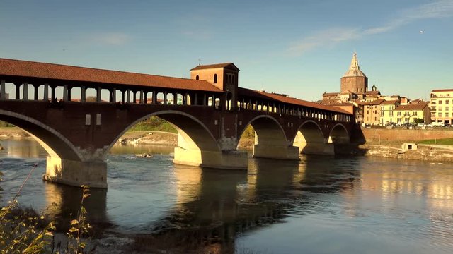 covered bridge  over the flowing waters of the Ticino river  in Pavia in Italy