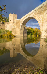 Fototapeta na wymiar The Puente de Alcantara, a Roman arch bridge in Toledo, Catile-La Mancha, Spain, spanning the Tagus River. The word comes from Arabic bridge