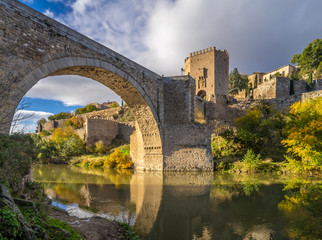 Fototapeta na wymiar The Puente de Alcantara, a Roman arch bridge in Toledo, Catile-La Mancha, Spain, spanning the Tagus River. The word comes from Arabic bridge