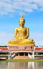Big golden buddha status on blue sky background
