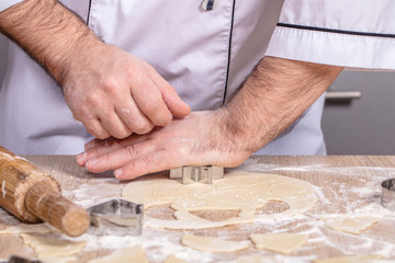 male cook preparing Christmas cookies