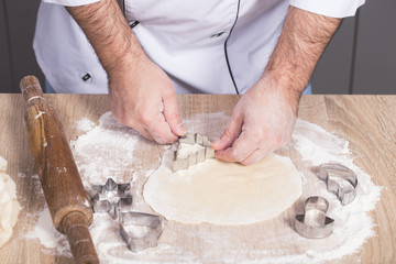 male cook preparing Christmas cookies