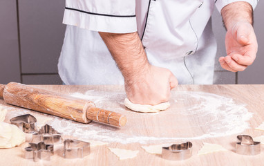 male cook preparing Christmas cookies