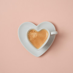 Heart shape coffee cup over pink background