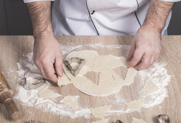 male cook preparing Christmas cookies