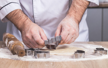 male cook preparing Christmas cookies