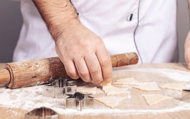 male cook preparing Christmas cookies