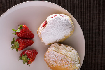 Sweet sandwich with cream and strawberries