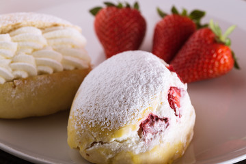 Sweet sandwich with cream and strawberries