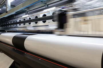 Massive machinery. Professional  printing facility, big vinyl rolls, ready for export. Glossy, matte, ecological materials used for commercial billboards, urban advertising, and oversized projects.