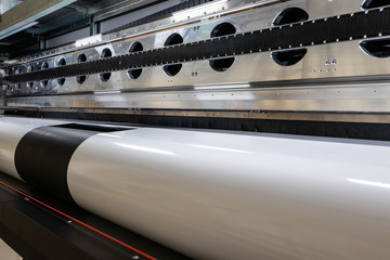 Massive machinery. Professional  printing facility, big vinyl rolls, ready for export. Glossy, matte, ecological materials used for commercial billboards, urban advertising, and oversized projects.