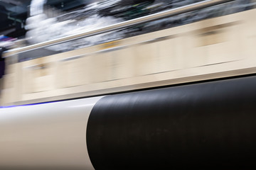 Fototapeta premium Massive machinery. Professional printing facility, big vinyl rolls, ready for export. Glossy, matte, ecological materials used for commercial billboards, urban advertising, and oversized projects.