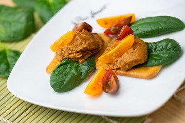 Vegetable carrot and miso paste spread on crackers 