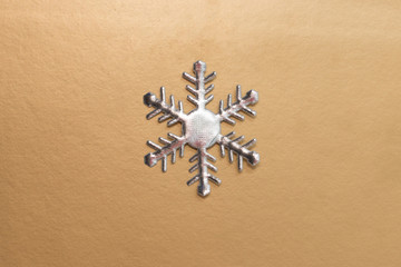 Christmas composition. One snowflake on gold background. Winter concept. Flat lay, top view, copy space