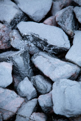 Ice and rocks on the beach. Frozen background
