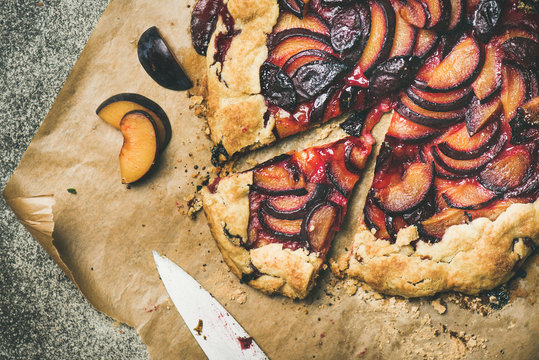 Flat-lay of plum galetta sweet cake on baking paper