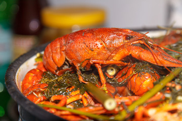Boiled crayfishes with herbs in a large saucepan.