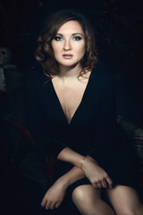 Beautiful model is posing in a dark studio