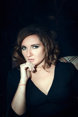 Beautiful model is posing in a dark studio