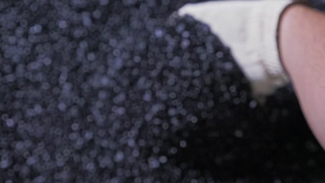 Plastic black gray granulated crumb. Manufacture of plastic water pipes of the factory. Process of making plastic tubes on the machine tool with the use of water and air pressure.