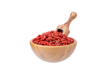 goji berry in a wooden bowl and a scoop isolated on white