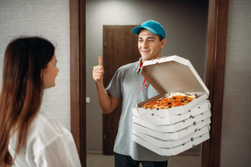 Pizza delivery boy shows thumbs up to customer