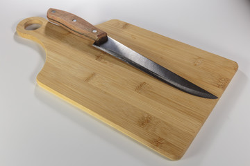 The knife on the cutting board cheese isolated on white close-up.