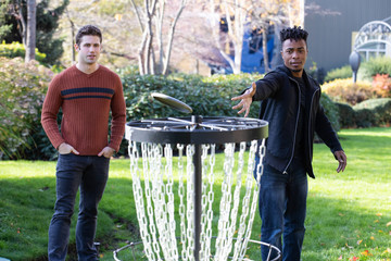 Two men playing disc golf