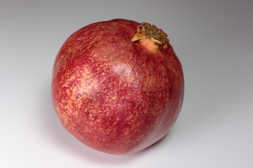 Juicy ripe pomegranates, isolated on white. Concept of vegan food.