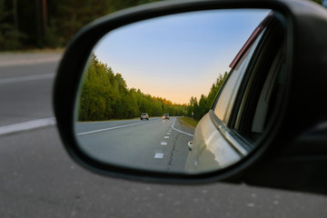 look in the rear view mirror of a car