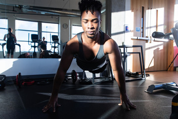 Fototapeta na wymiar Healthy man exercising in a gym