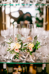 wedding attributes such as earrings, flowers, glasses, candle