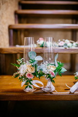 wedding attributes such as earrings, flowers, glasses, candle