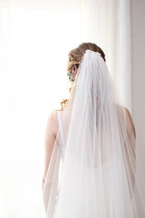 a bride on her back with white veil and dress